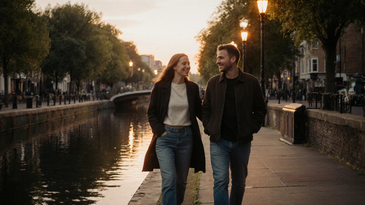 A couple walking peacefully along Hackney&#039;s Regent’s Canal at sunset.