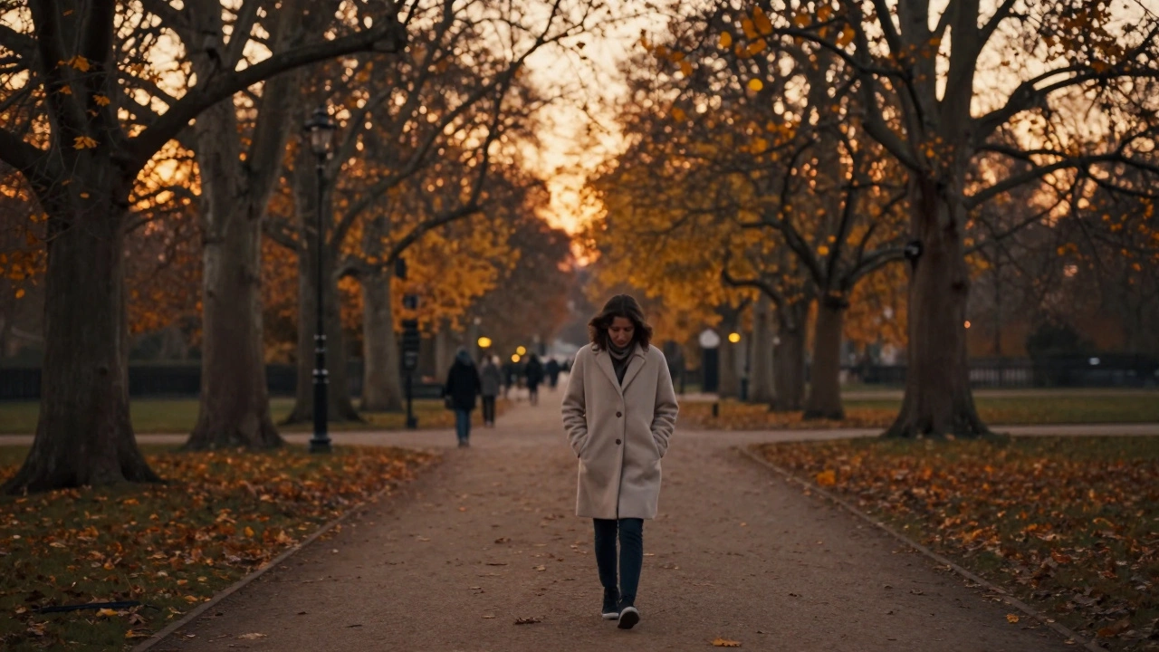 A person walking alone in a London park at sunset, surrounded by golden autumn light, peaceful and reflective.