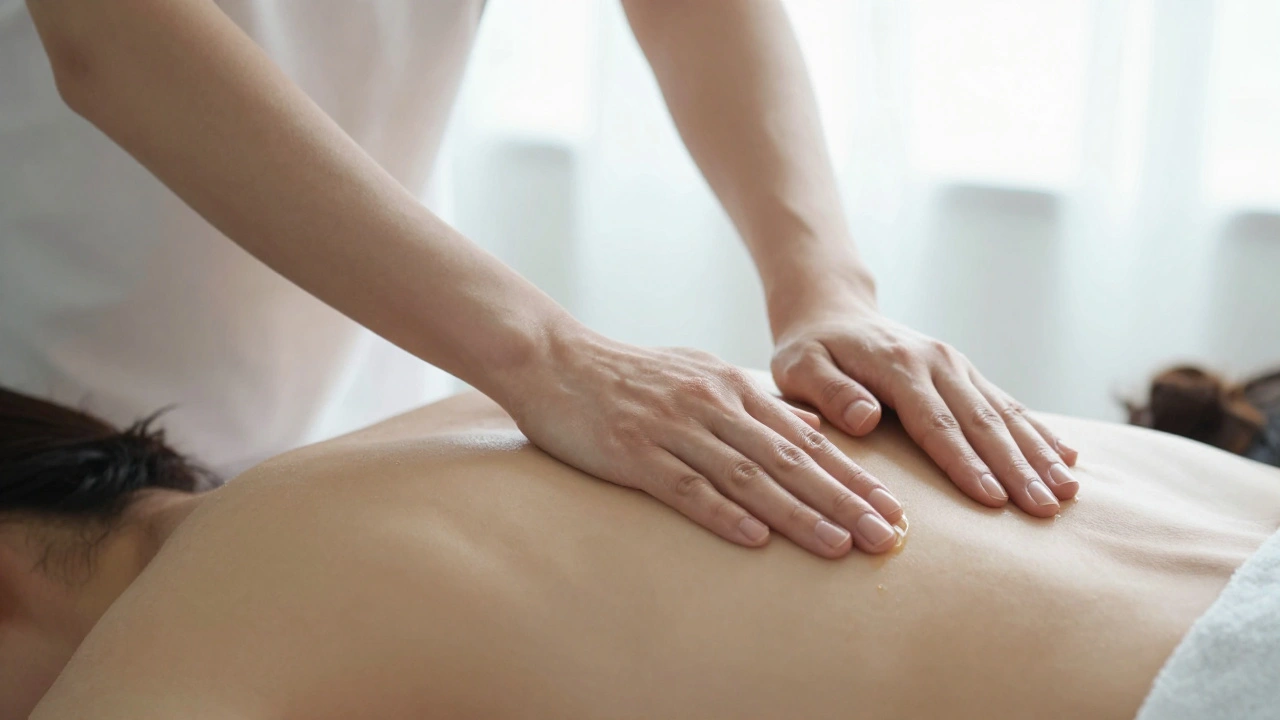 Hands gently applying oil to a back with soft focus, evoking trust and therapeutic touch in a serene setting.