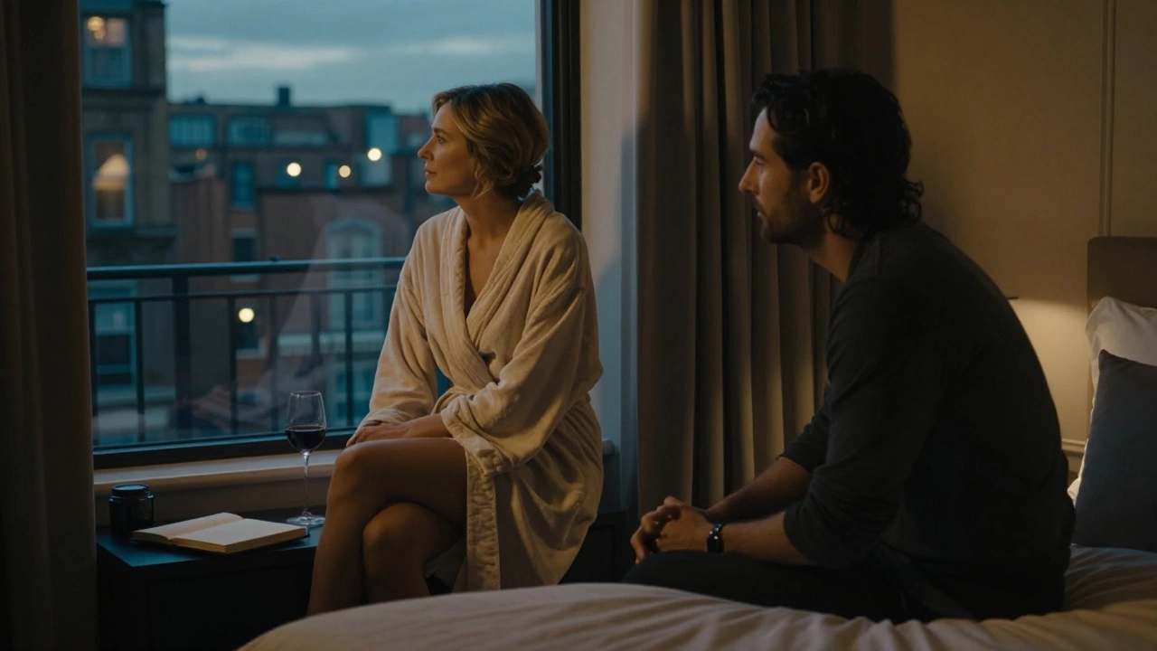 A mature escort and client in a warm hotel suite at dusk, gazing out the window in peaceful reflection.