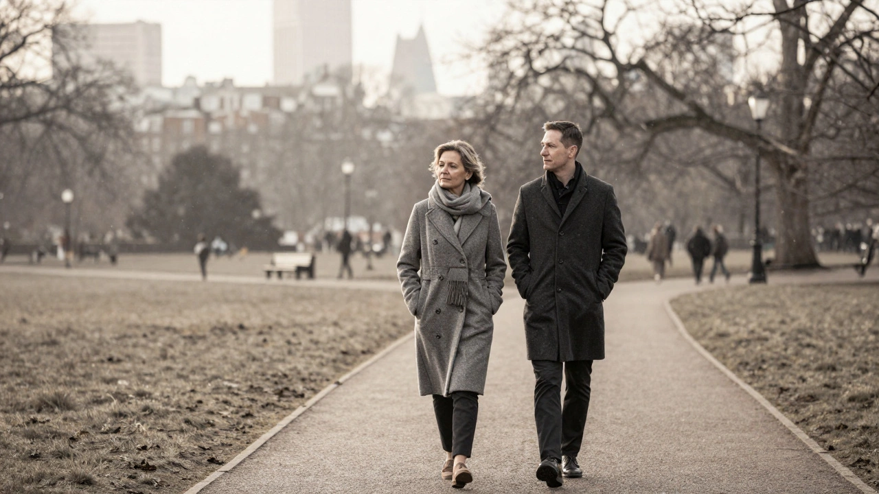 A mature woman and man walking silently through Hyde Park in winter, surrounded by soft snowfall.