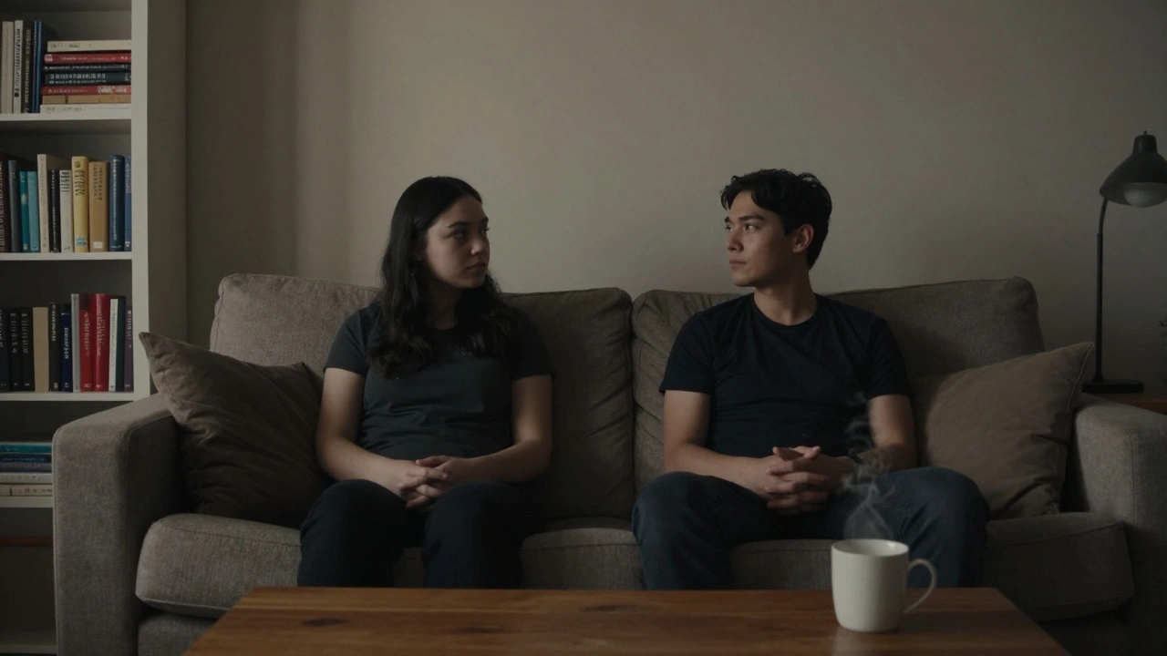 Two silhouettes sitting side by side on a couch in quiet companionship, warm lamplight filling the room.